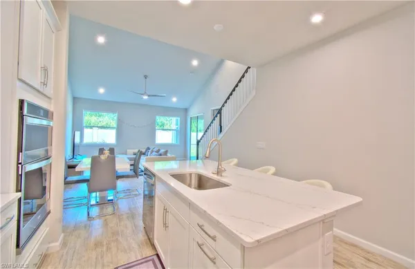 a bathroom with a granite countertop sink mirror and a toilet