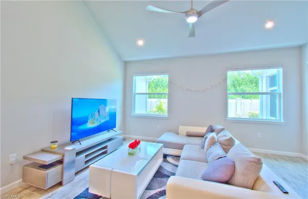 a living room with furniture and a wooden floor