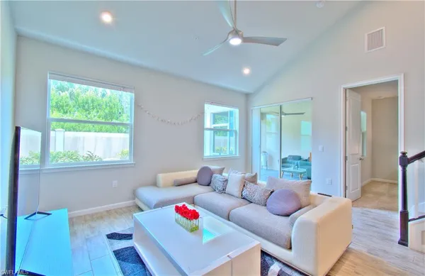 a living room with furniture and a wooden floor