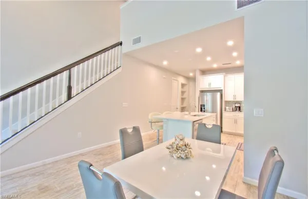a living room with furniture a window and a flat screen tv