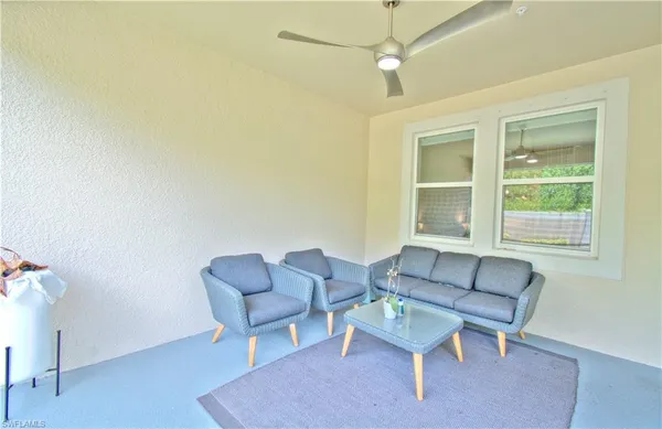 a living room with a window and a table