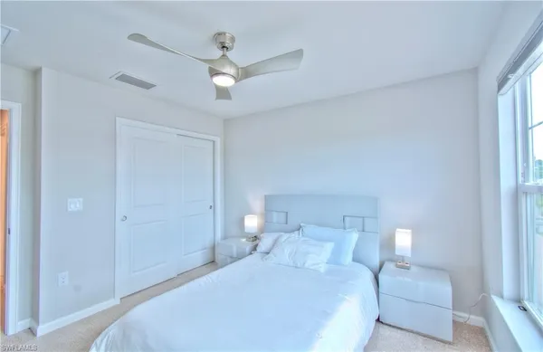 a bedroom with a large bed and a large window