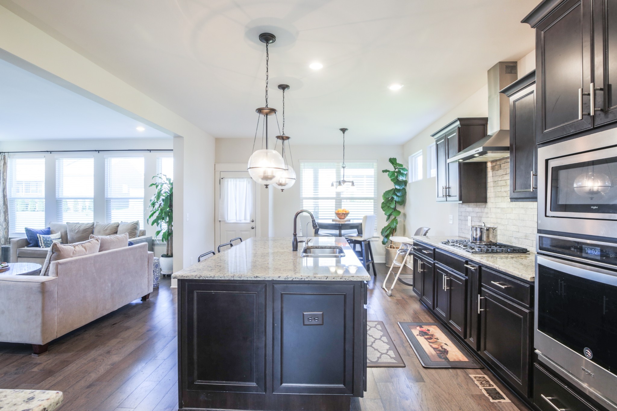 619 Beamon Drive Franklin, TN 37064 - Photo 13 of 43 a large kitchen with stainless steel appliances a large counter top a sink a stove and wooden floor