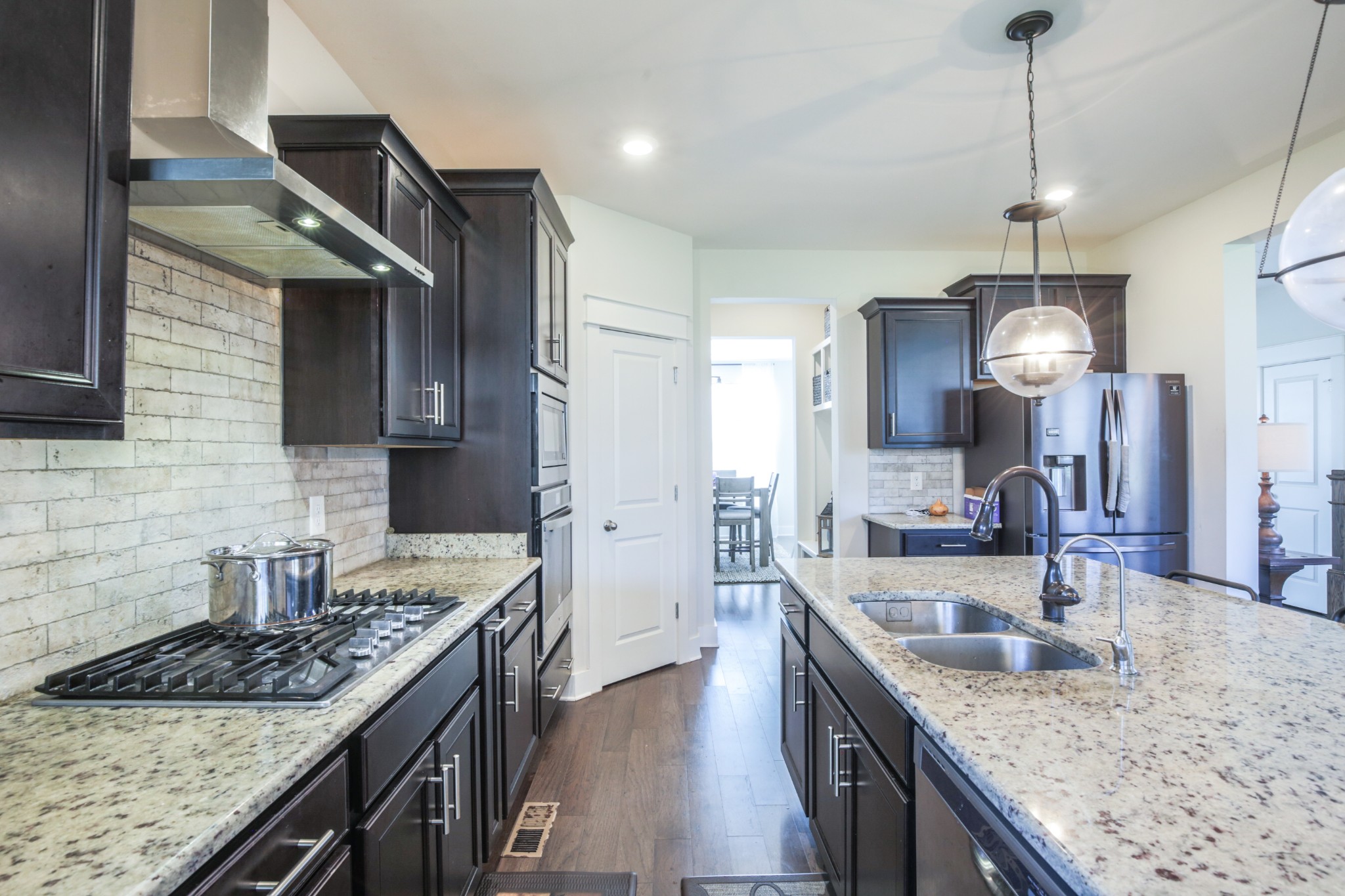 619 Beamon Drive Franklin, TN 37064 - Photo 15 of 43 a kitchen with granite countertop stainless steel appliances a sink stove and refrigerator