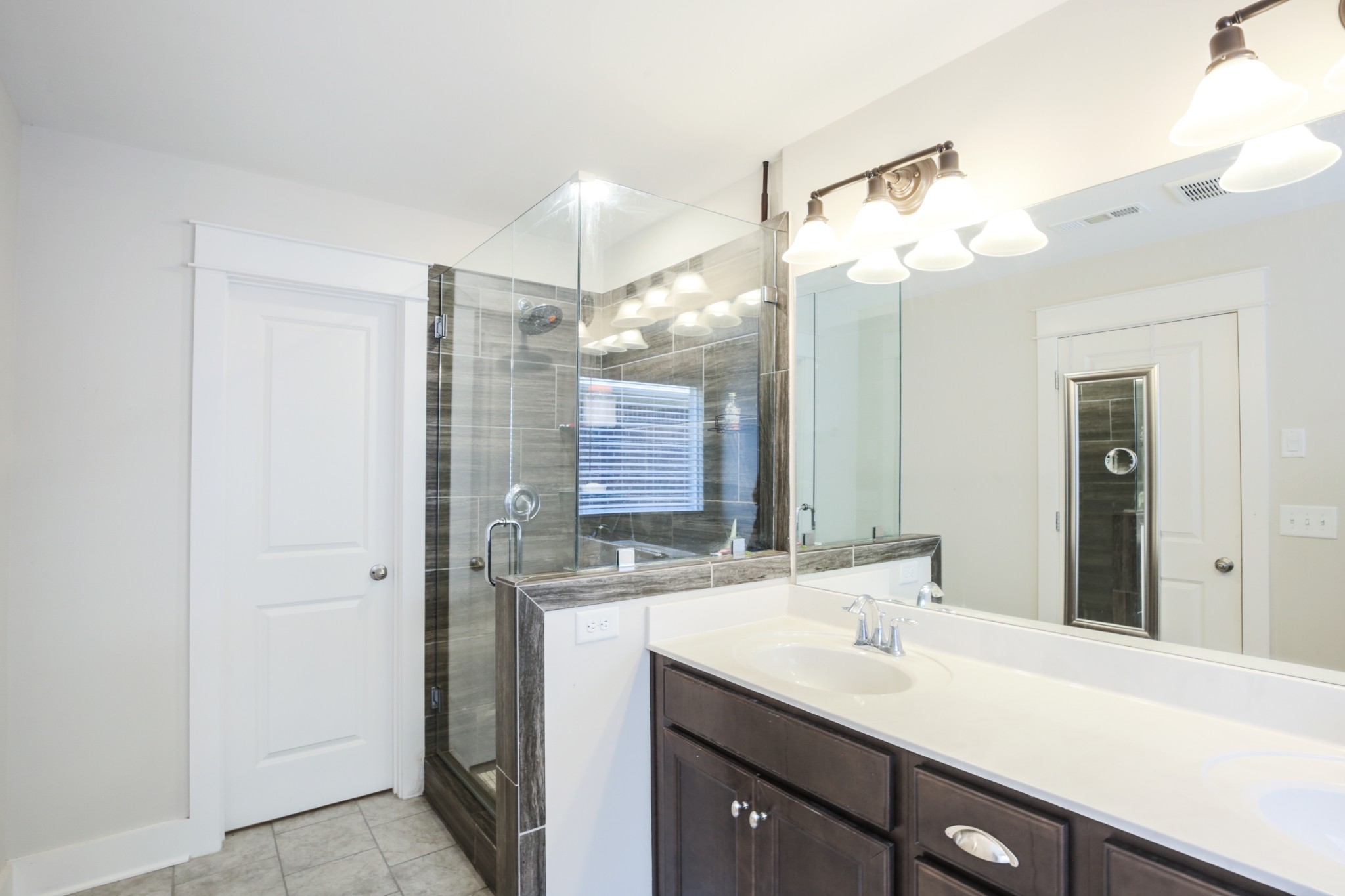 619 Beamon Drive Franklin, TN 37064 - Photo 28 of 43 a bathroom with a sink a mirror and a shower