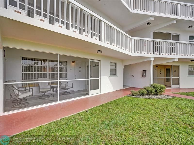 600 Pine Drive, Unit 106 Pompano Beach, FL 33060 - Photo 2 of 15 a porch with a table and chairs and potted plants