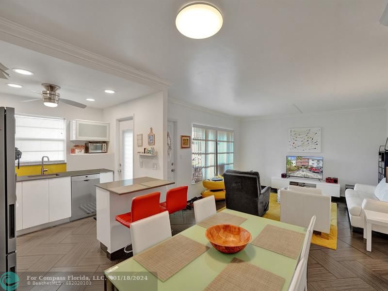 600 Pine Drive, Unit 106 Pompano Beach, FL 33060 - Photo 5 of 15 a kitchen with a dining table chairs and living room