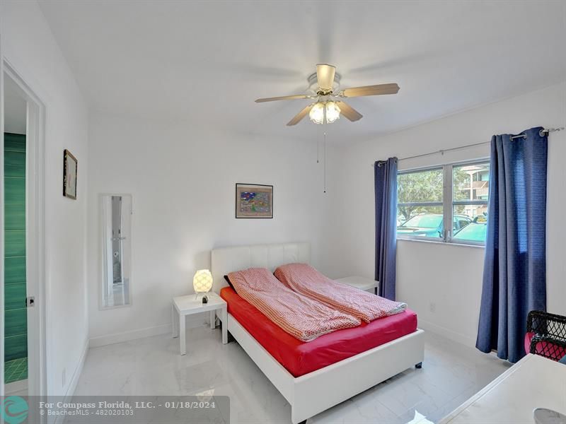 600 Pine Drive, Unit 106 Pompano Beach, FL 33060 - Photo 7 of 15 a bedroom with a bed and a chandelier