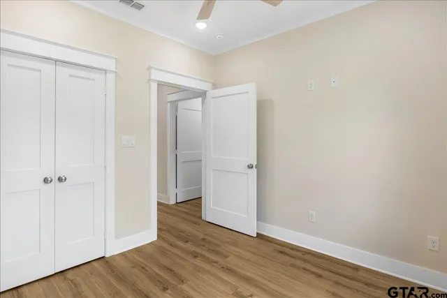 a view of an empty room with wooden floor