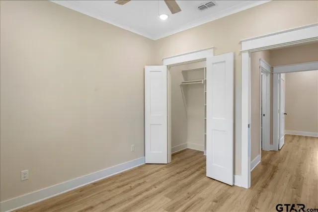 a view of a hallway with wooden floor