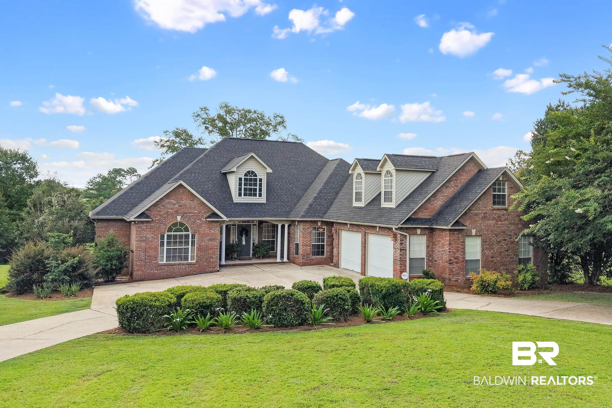 197 Morning Ridge Road Monroeville, AL 36460 - Photo 2 of 51 Brick exterior with a dark-shingle roof and multiple dormer windows