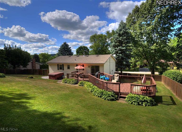1966 Connect Road Barberton, OH 44203 - Photo 14 of 15 Backyard view 1 - this view highlights the oversized deck, surrounded by beautiful hostas!