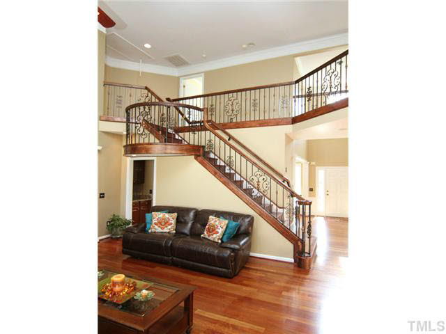7601 Vista Del Rey Lane Raleigh, NC 27613 - Photo 7 of 24 Brazilian Hardwood Cherry Hardwood floor are throughout the first and second floor. Custom stair-rail was also added, making this room a real show piece! Den/Family/Great Room