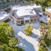 an aerial view of a house with a yard basket ball court and outdoor seating