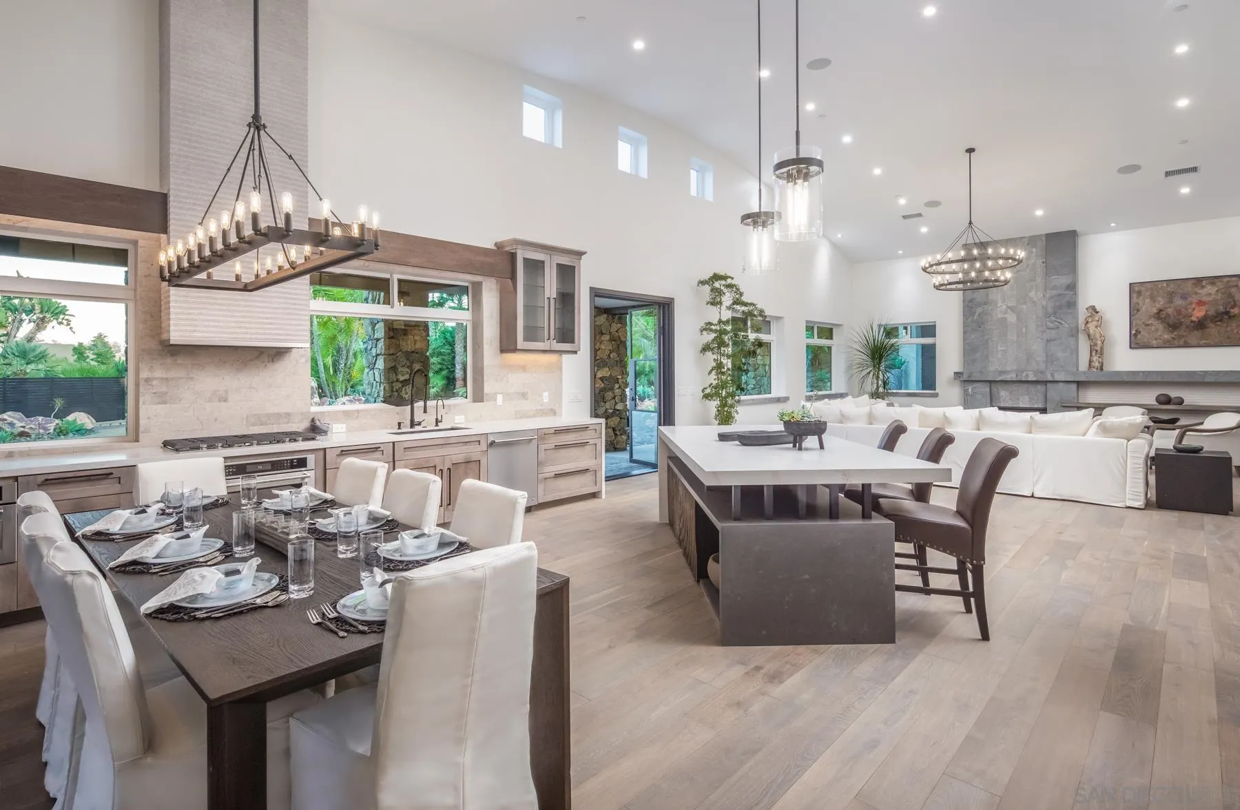 1240 Berryman Canyon Encinitas, CA 92024 - Photo 13 of 66 a living room with furniture a large window and a chandelier