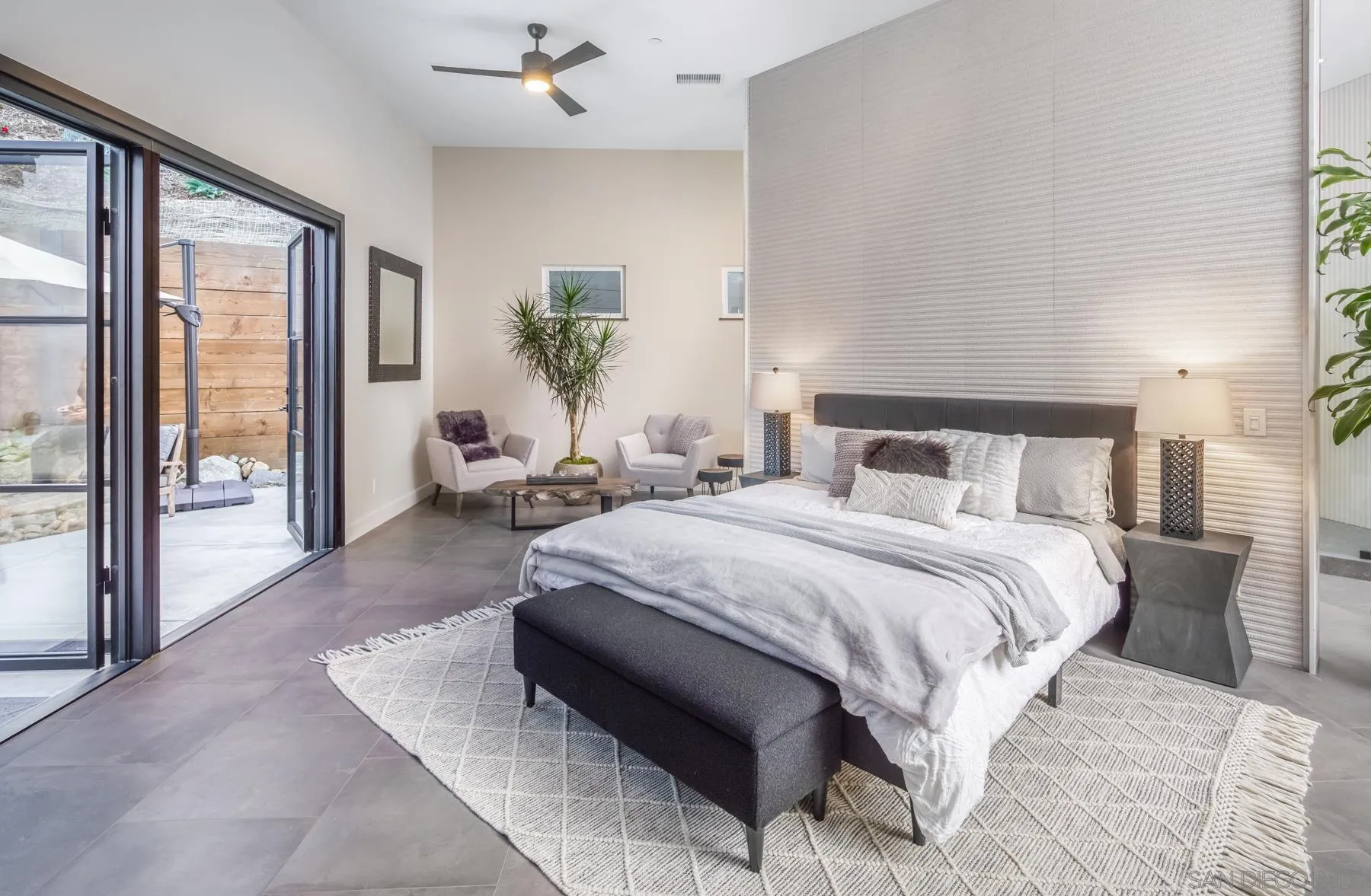 1240 Berryman Canyon Encinitas, CA 92024 - Photo 22 of 66 a bedroom with a large bed couch and a large window