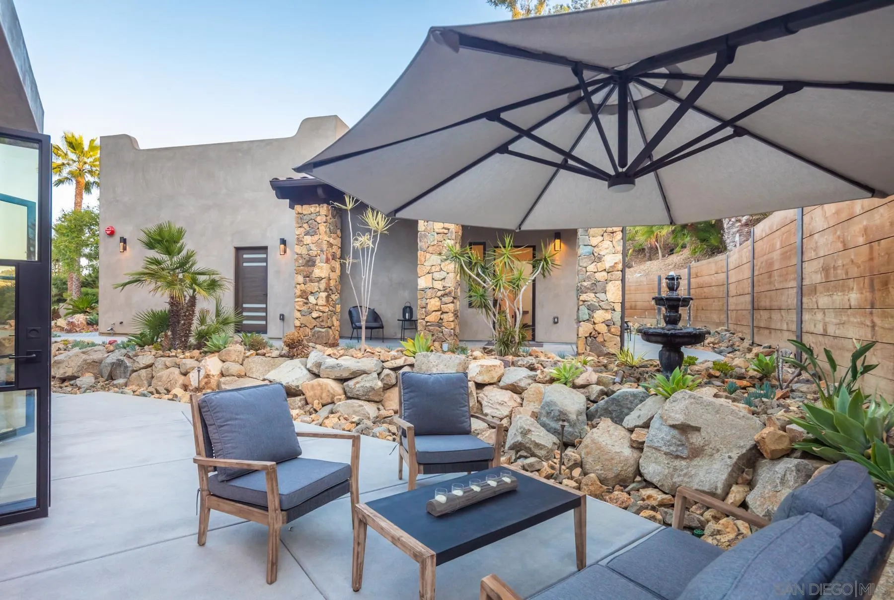 1240 Berryman Canyon Encinitas, CA 92024 - Photo 23 of 66 a living room with patio furniture and a potted plant