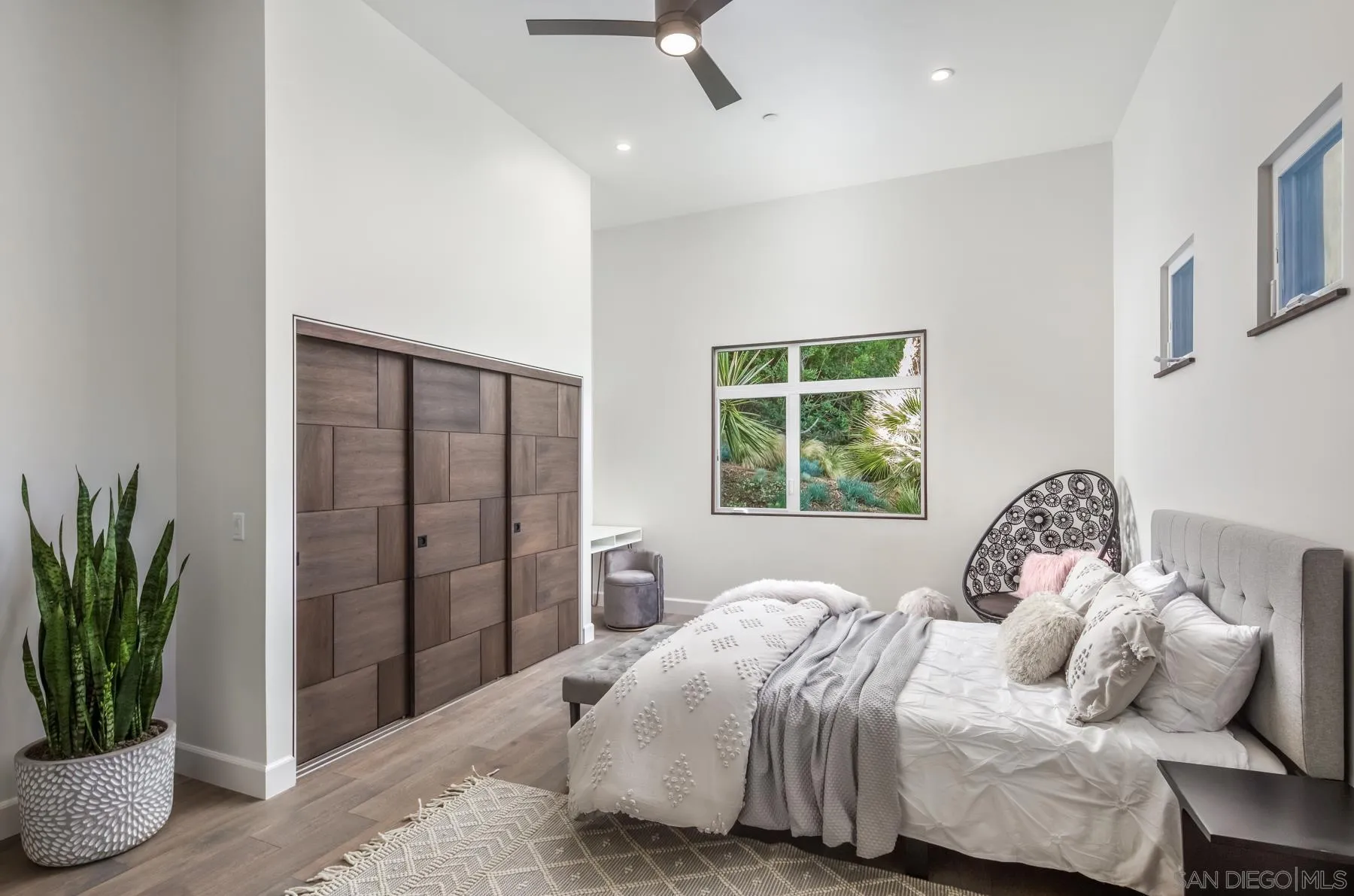 1240 Berryman Canyon Encinitas, CA 92024 - Photo 36 of 66 a bedroom with a bed and a potted plant