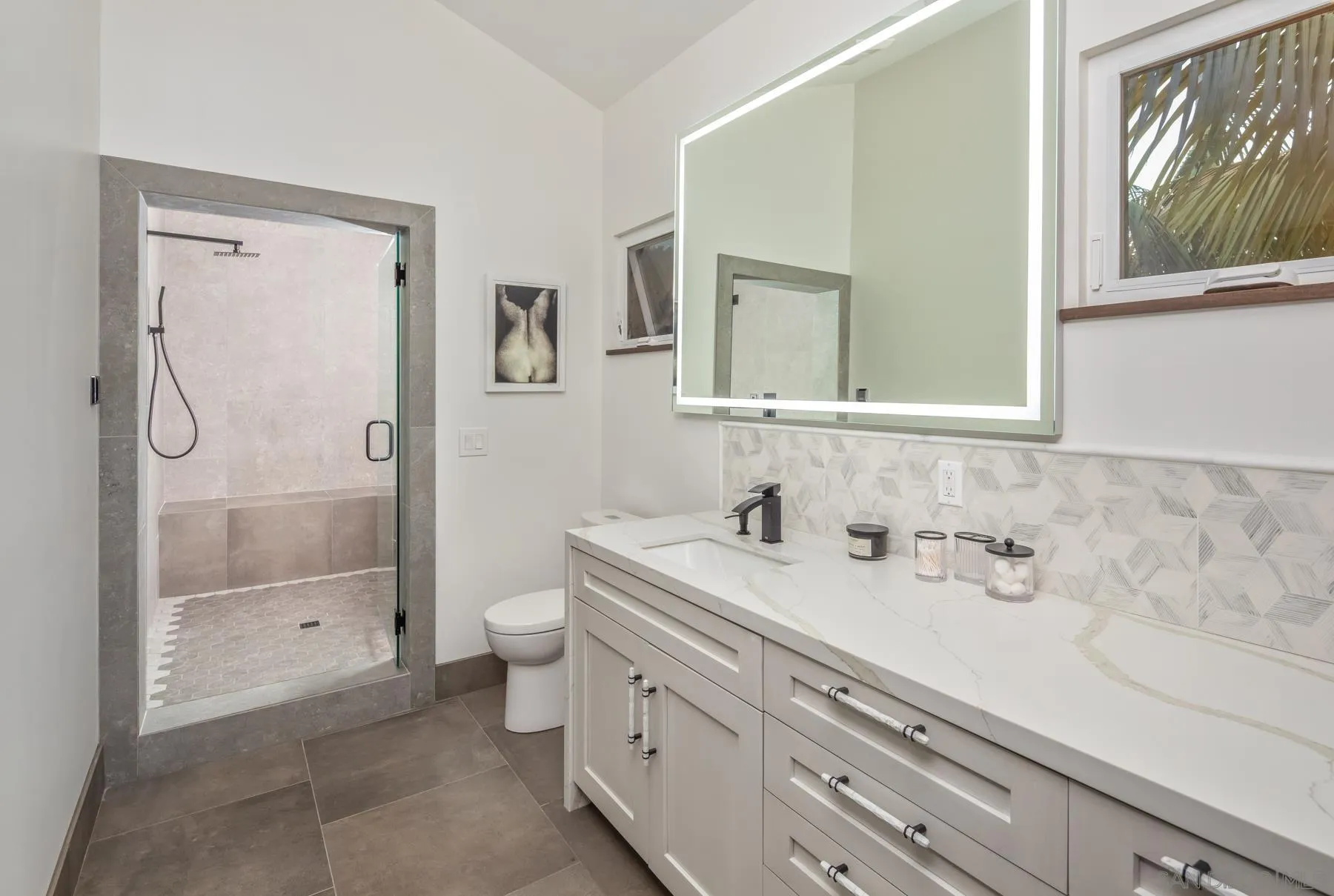 1240 Berryman Canyon Encinitas, CA 92024 - Photo 45 of 66 a bathroom with a granite countertop sink a toilet and a shower