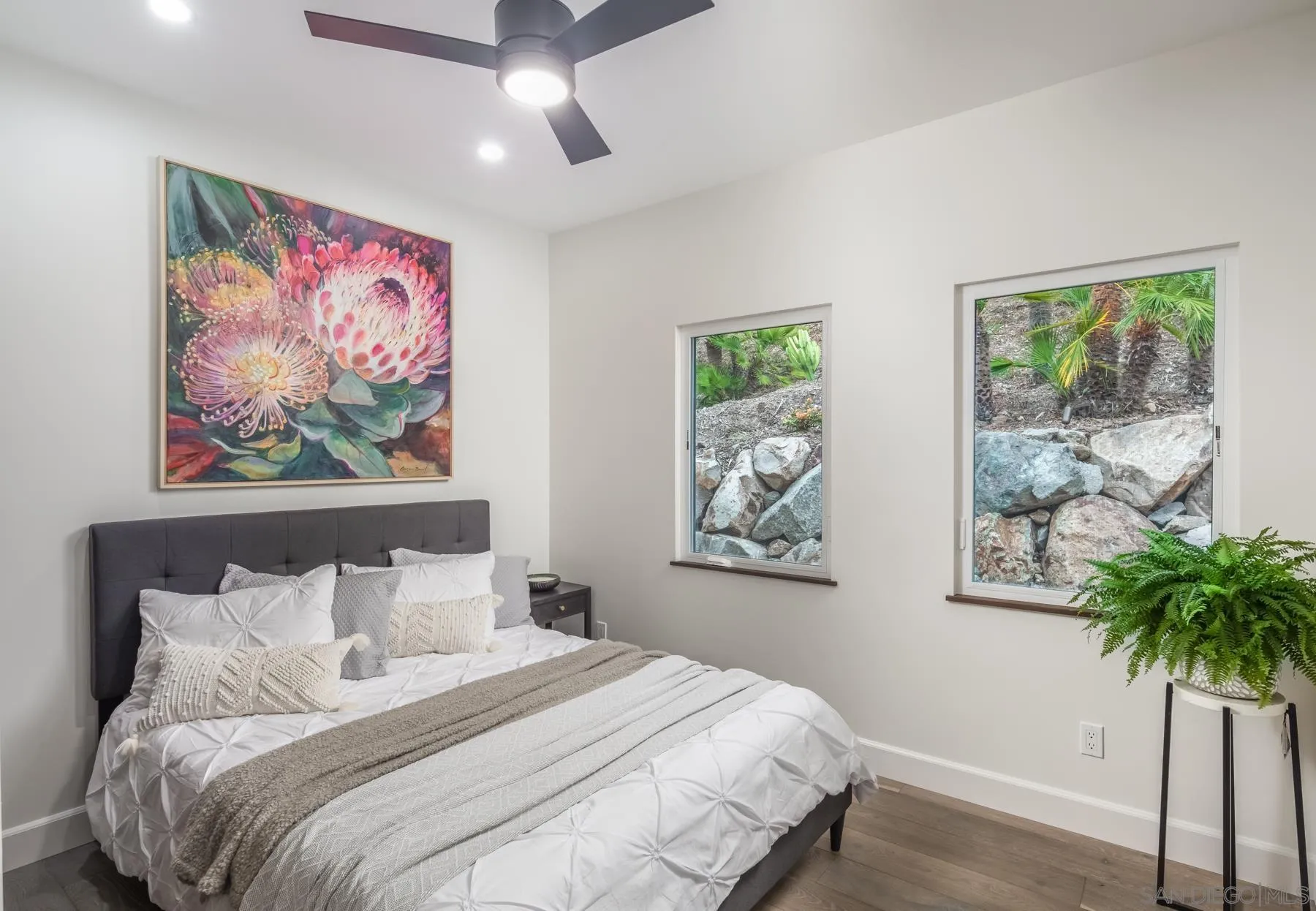 1240 Berryman Canyon Encinitas, CA 92024 - Photo 47 of 66 a bedroom with a large bed and a painting on the wall