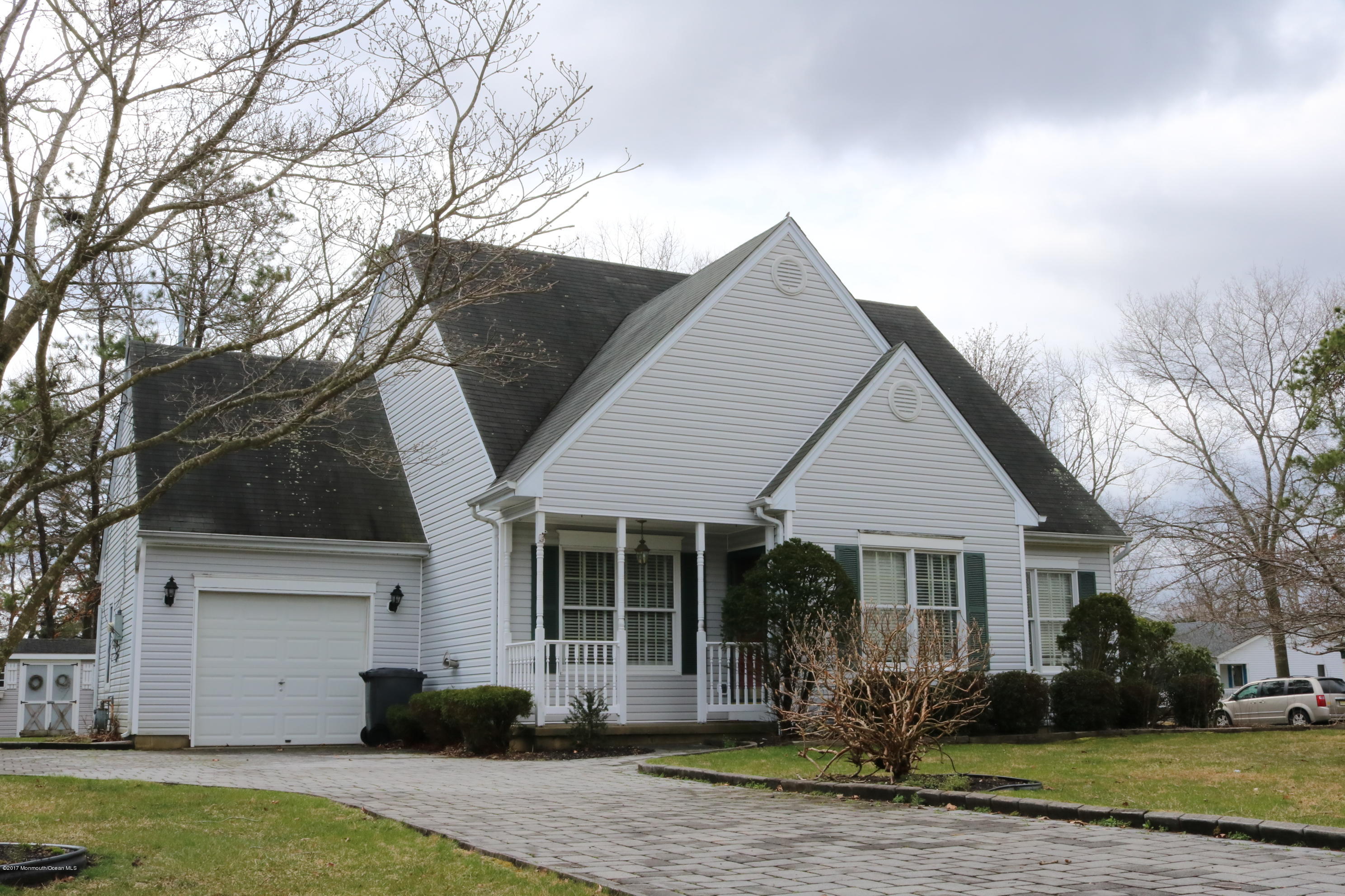 164 Equinox Road Manahawkin, NJ 08050 - Photo 1 of 35 a front view of a house with a yard and garage