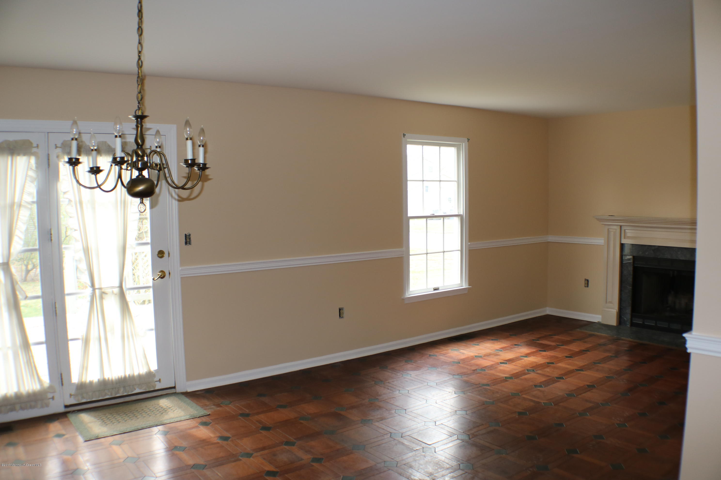 164 Equinox Road Manahawkin, NJ 08050 - Photo 11 of 35 a view of an empty room with wooden floor and a window