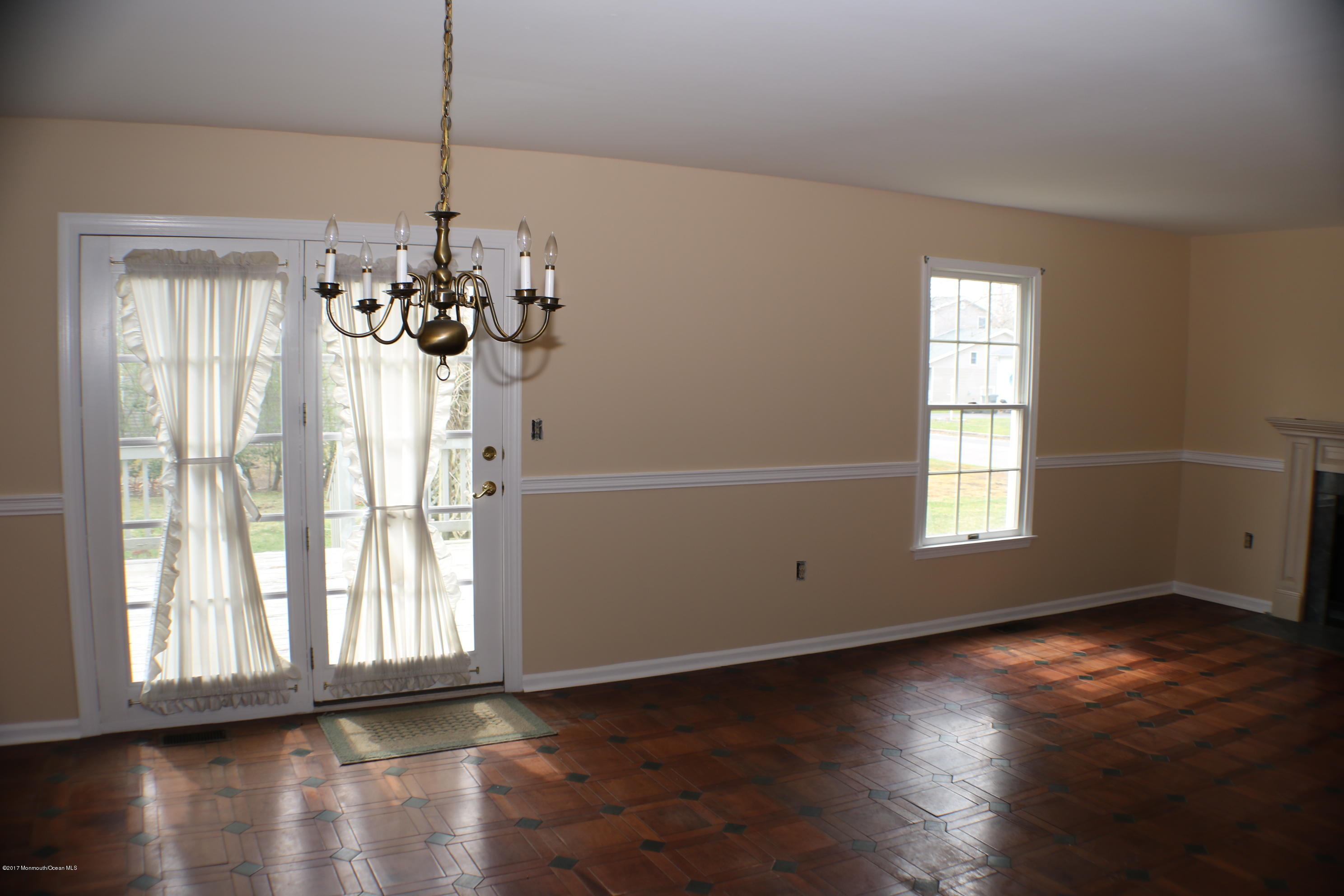 164 Equinox Road Manahawkin, NJ 08050 - Photo 13 of 35 a view of an empty room with wooden floor and a window