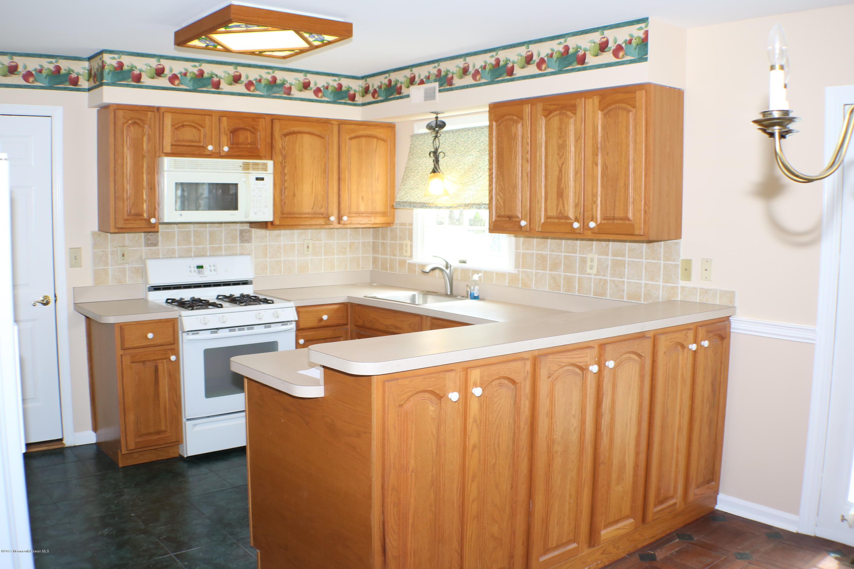 164 Equinox Road Manahawkin, NJ 08050 - Photo 16 of 35 a kitchen with stainless steel appliances granite countertop a sink a stove and a refrigerator