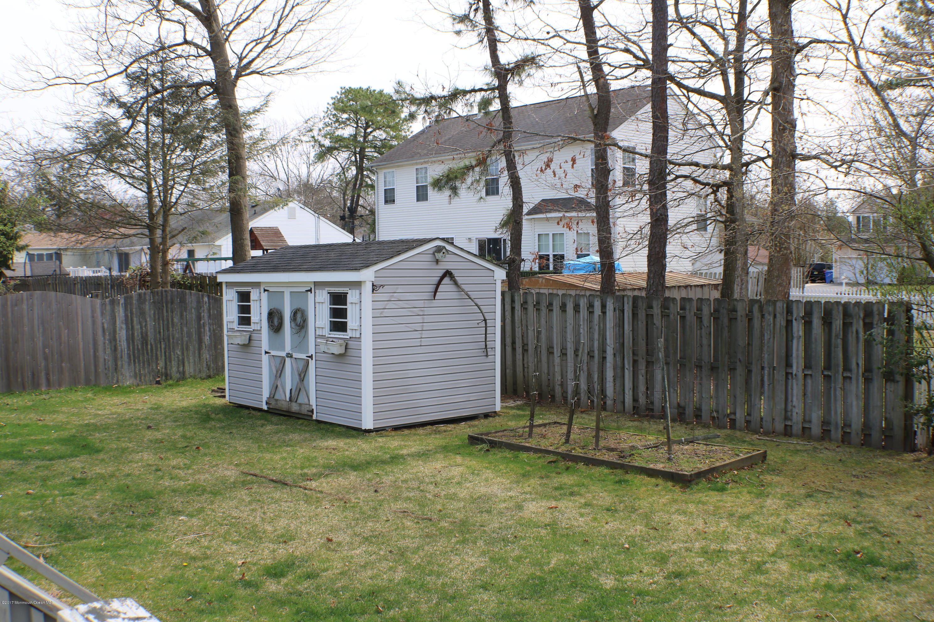 164 Equinox Road Manahawkin, NJ 08050 - Photo 20 of 35 a view of a house with a yard and wooden fence