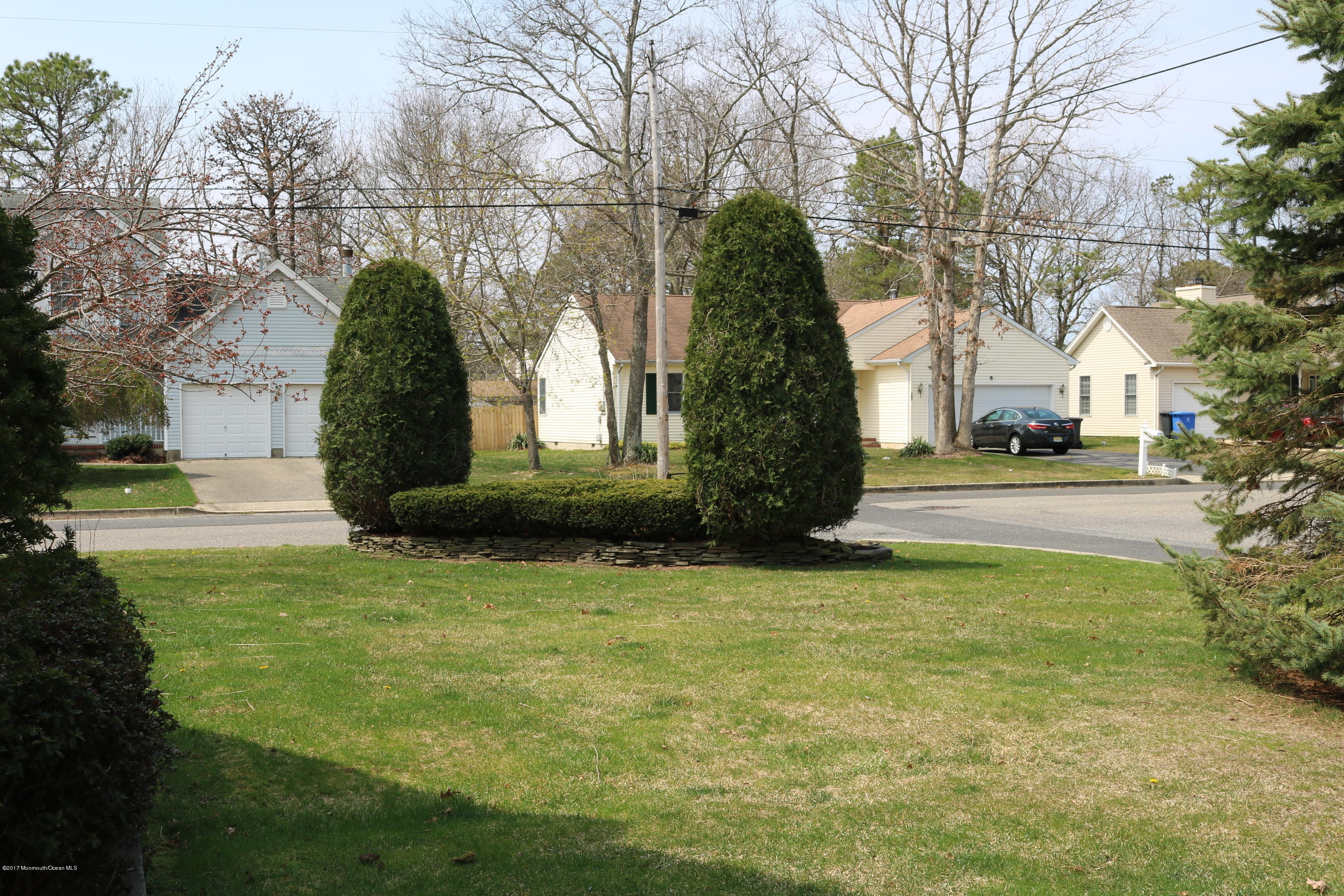 164 Equinox Road Manahawkin, NJ 08050 - Photo 29 of 35 a front view of a house with garden and trees