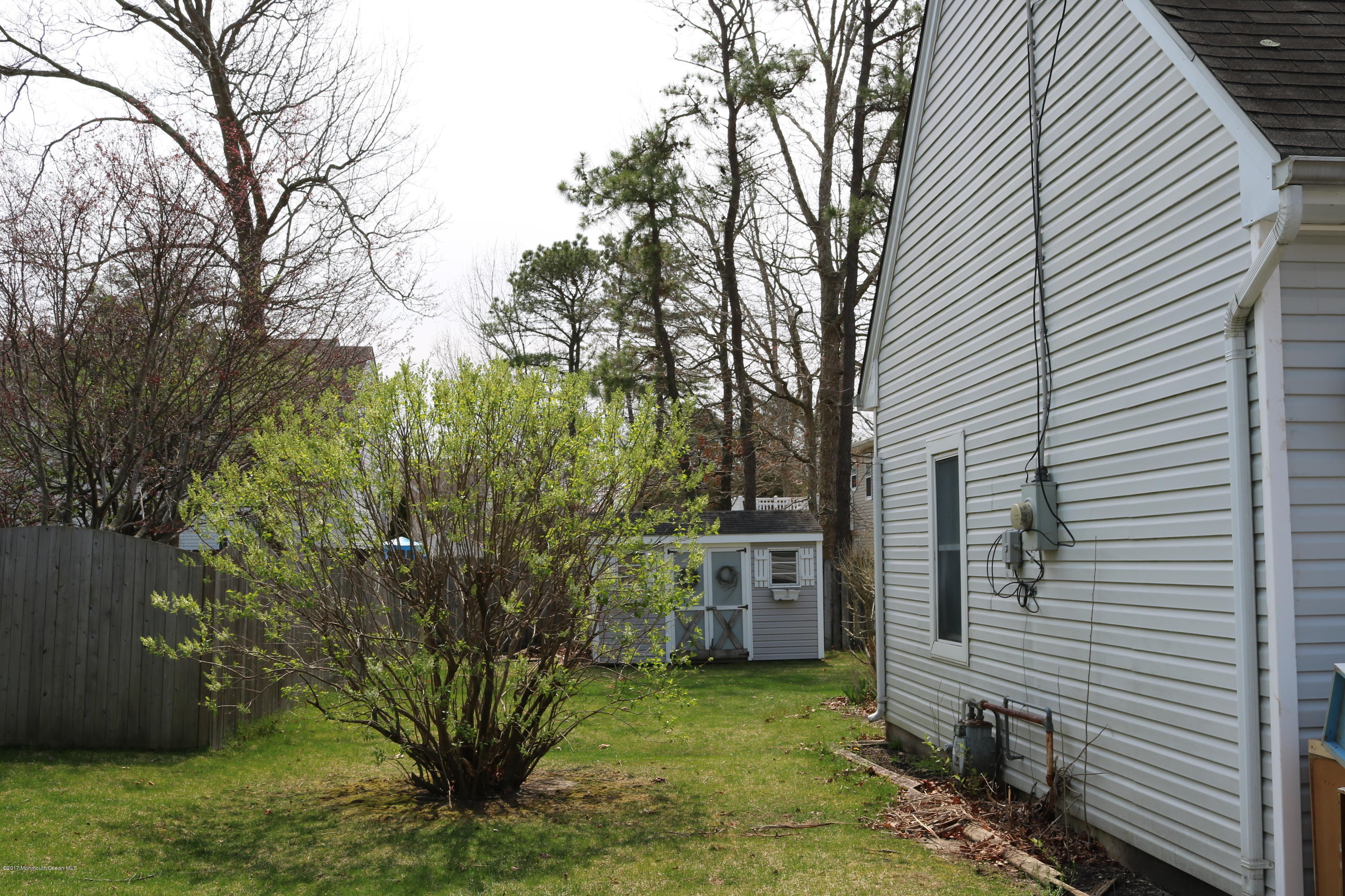 164 Equinox Road Manahawkin, NJ 08050 - Photo 32 of 35 a view of a backyard with plants and large tree