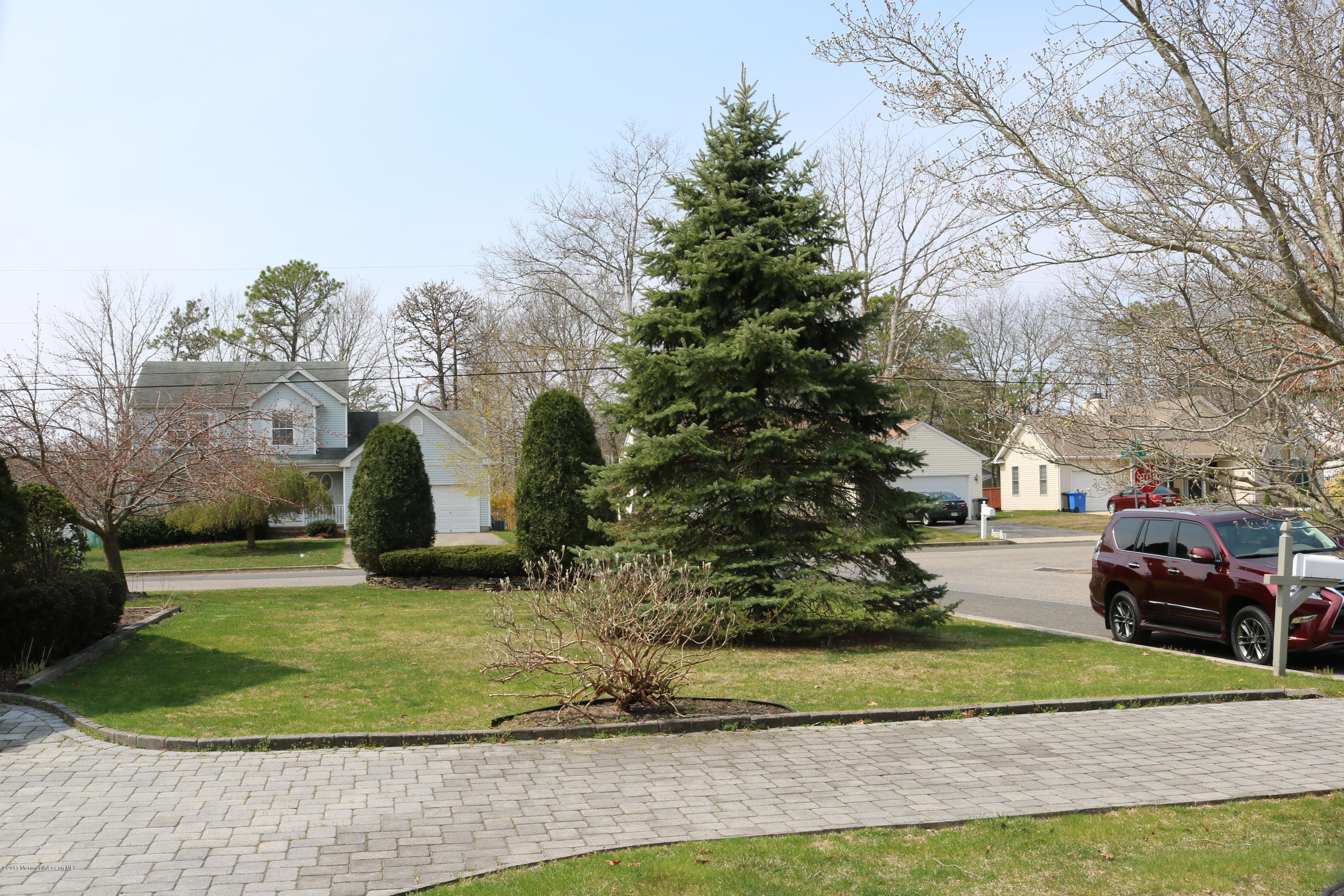 164 Equinox Road Manahawkin, NJ 08050 - Photo 33 of 35 a front view of a house with a yard and trees