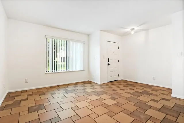 a view of an entryway with wooden floor