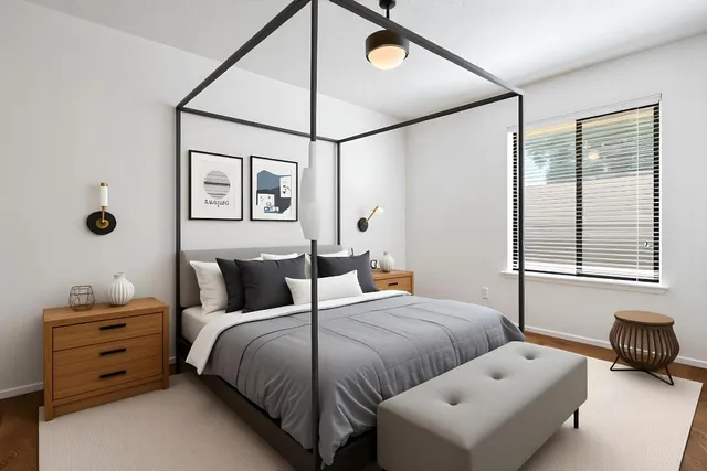 a bedroom with bed and a window