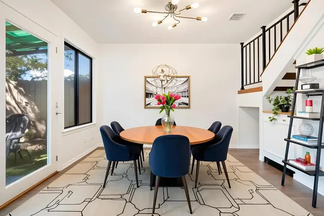 a view of a dining room with furniture and a potted plant
