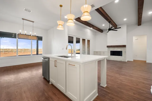 a kitchen with stainless steel appliances a white stove top oven a fireplace and a large window