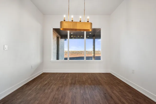 a view of a room with wooden floor furniture and a window