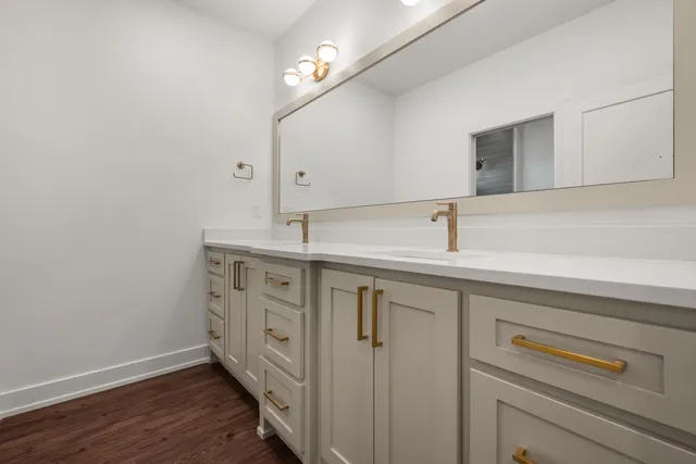 a kitchen with a sink and a mirror