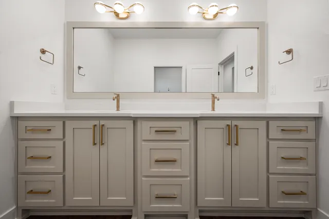 a bathroom with a sink vanity and a mirror