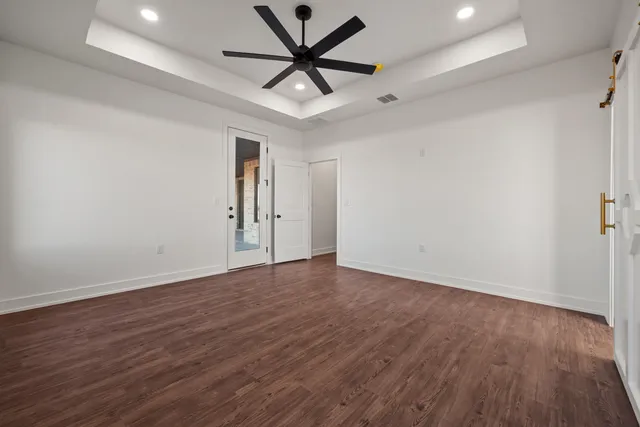 a view of an empty room and wooden floor