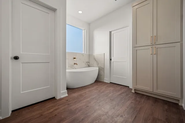 a bathroom with a bathtub and shower