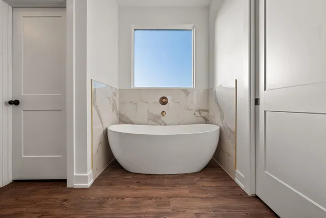 a bathroom with a granite countertop sink mirror and shower