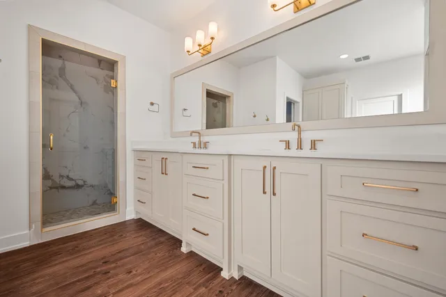 a view of a kitchen with cabinets and wooden floor