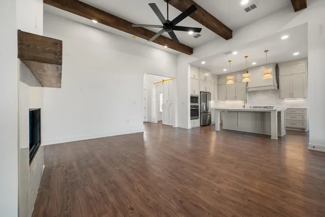 a view of a kitchen with a sink and a refrigerator
