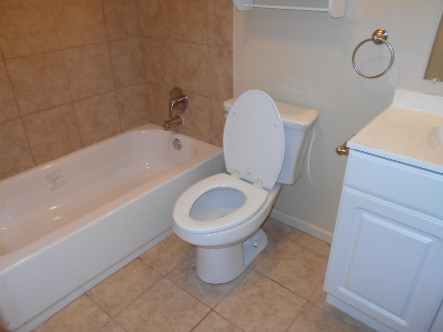 5401 14th Street Lubbock, TX 79416 - Photo 12 of 17 a bathroom with a toilet and a bathtub