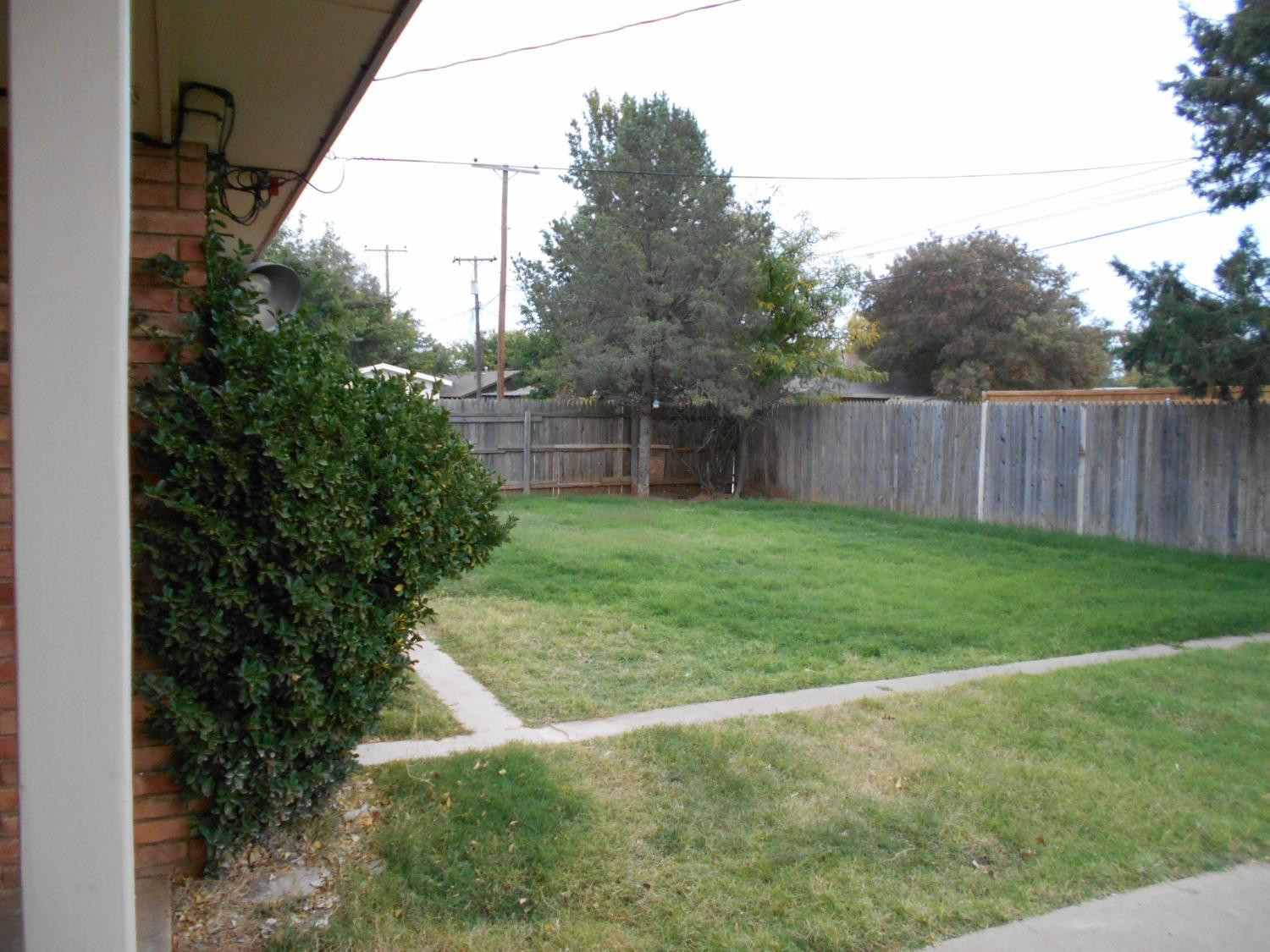 5401 14th Street Lubbock, TX 79416 - Photo 16 of 17 a view of backyard with wooden fence