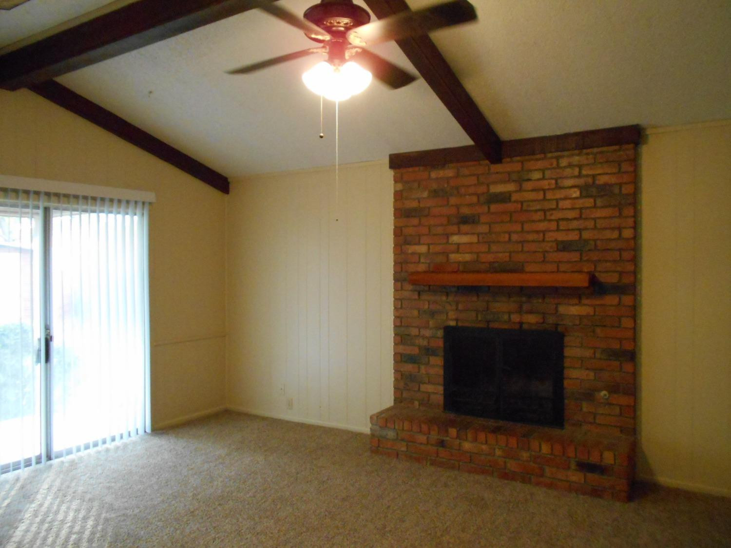 5401 14th Street Lubbock, TX 79416 - Photo 4 of 17 a view of empty room with fireplace and fan