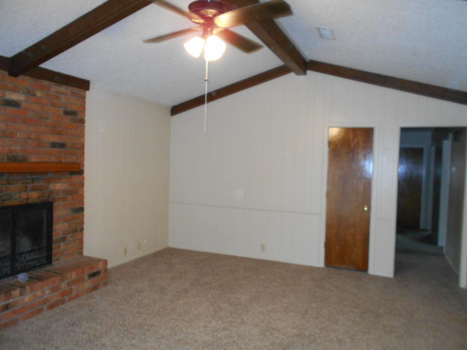 5401 14th Street Lubbock, TX 79416 - Photo 5 of 17 an empty room with closet and a chandelier fan