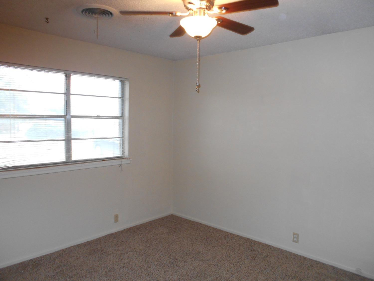 5401 14th Street Lubbock, TX 79416 - Photo 10 of 17 an empty room with a window