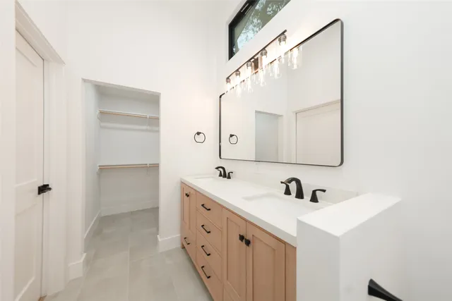 a bathroom with a double vanity sink mirror and